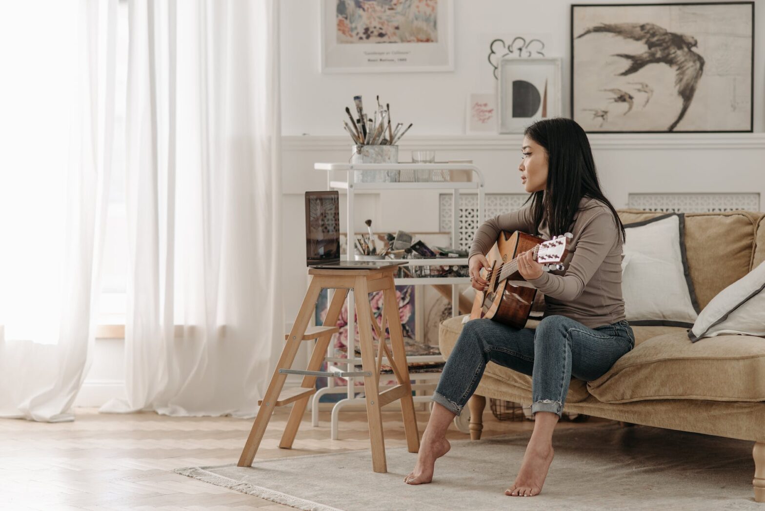 woman learning how to play a guitar